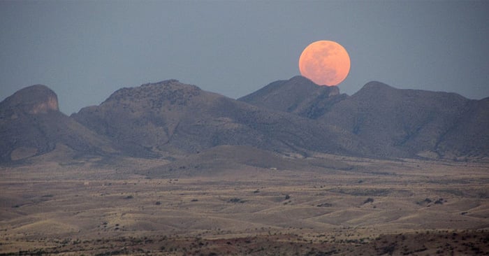 Full Supermoon rising over mountains