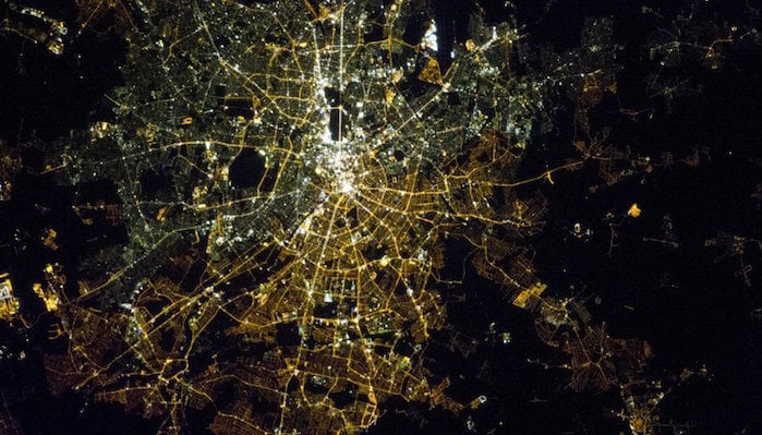 A satellite image of Berlin at night showing the difference between the lights of west and east Berlin.