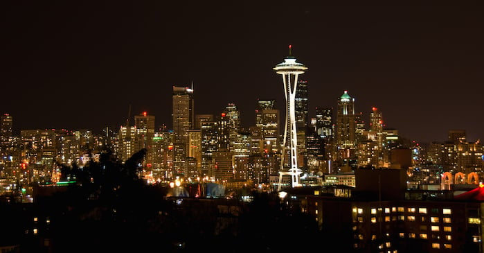 The City of Seattle, Washington, skyline at night with the Space Needle in the foreground.