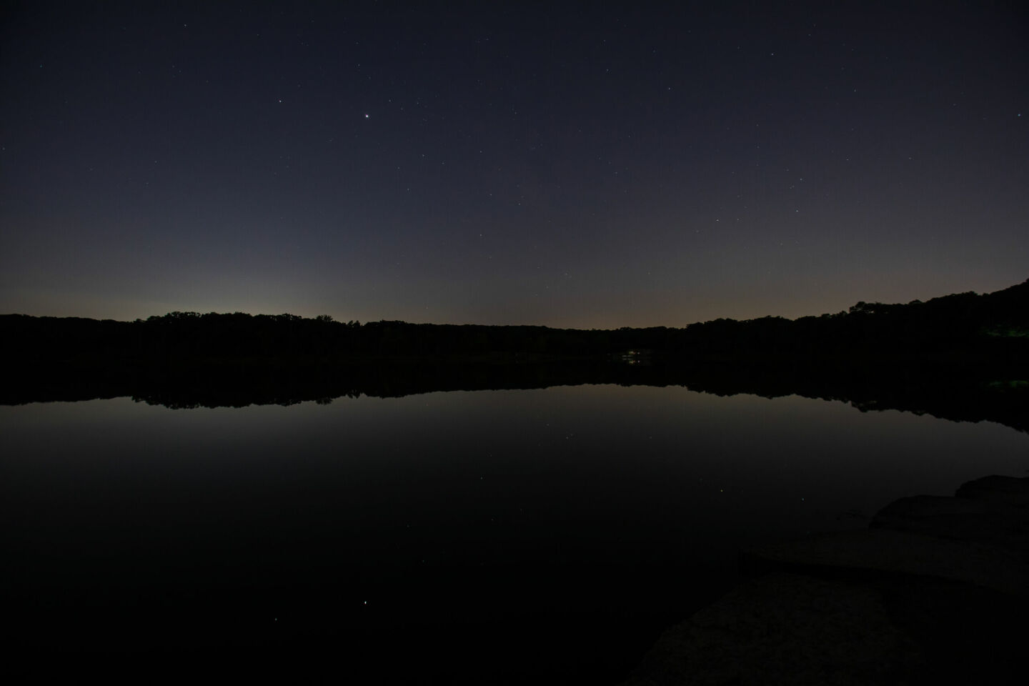 Image depicting the Urban Night Sky Place at night overlooking Maple Lake.